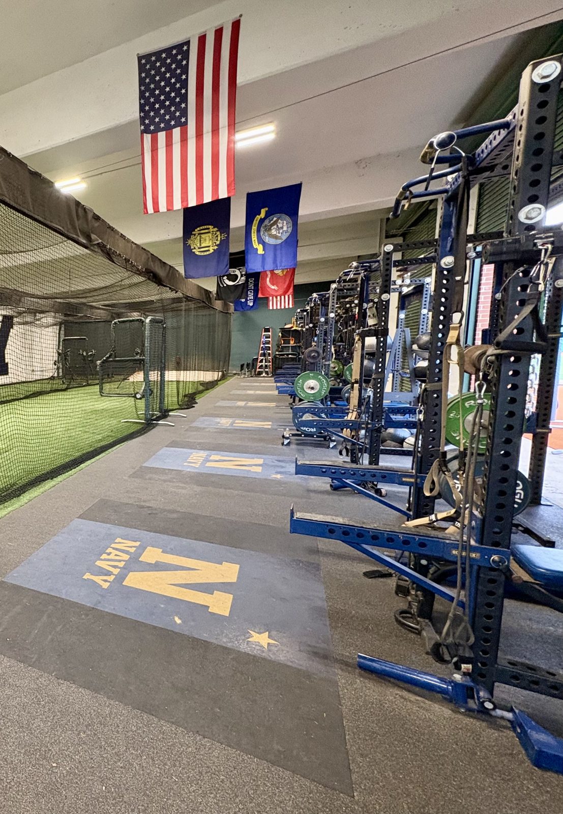 Indoor batting cages and racks under the flags
