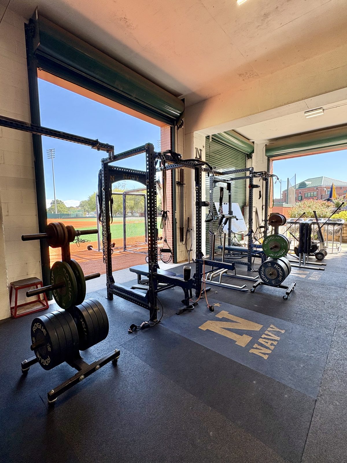 Weight racks in the indoor facility opening directly onto the field